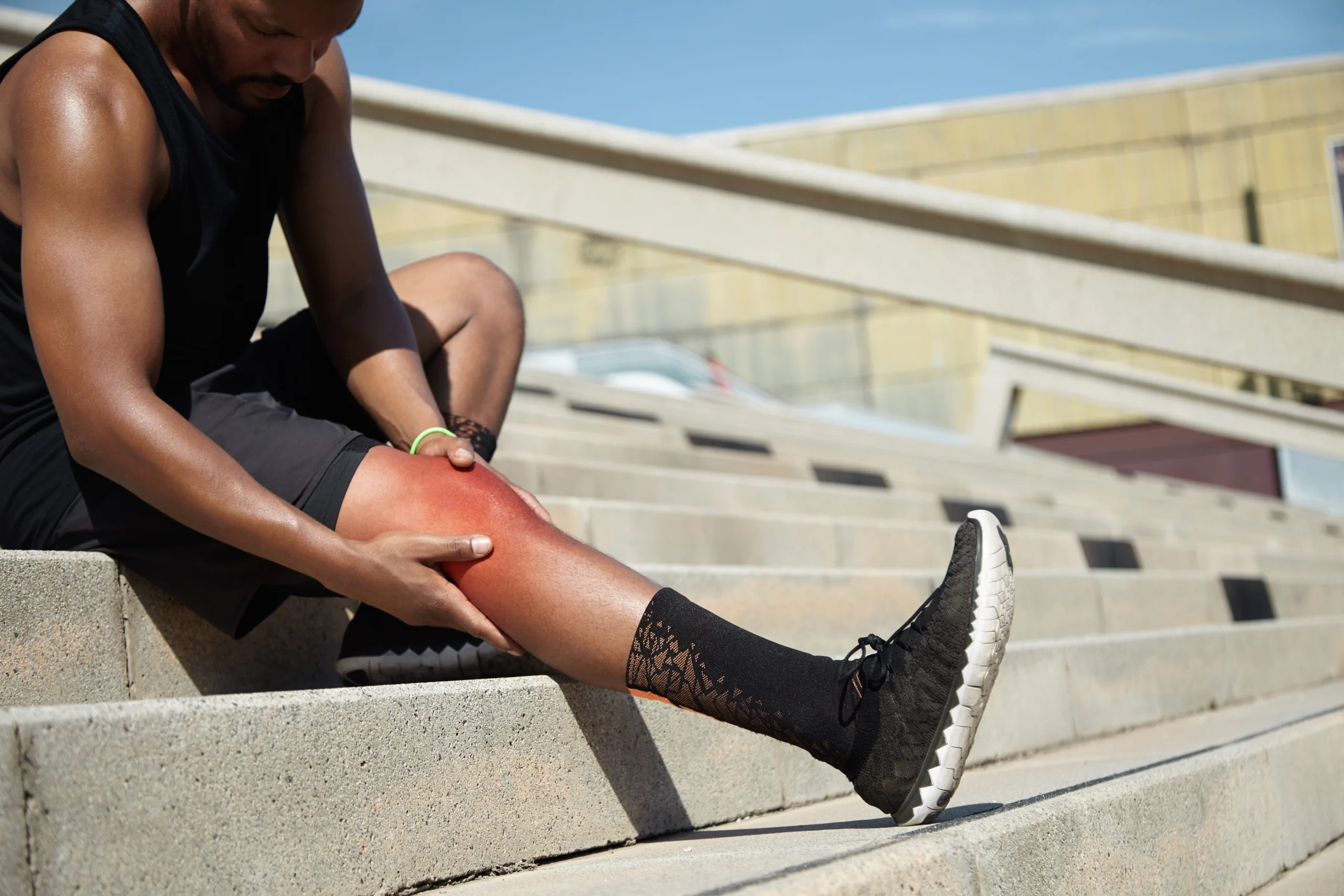closeup young man with knee injury scaled