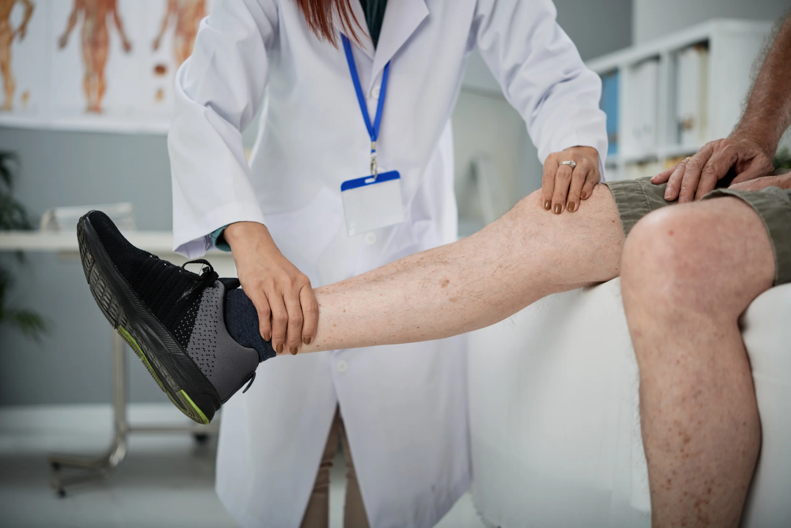 physiotherapist palpating leg scaled