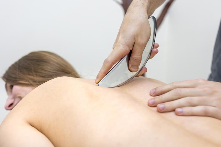 rehab doctor performs iastm tool massage patient back gua sha therapy 169016 71523